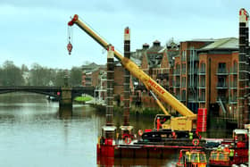 A crane manouvres onto a barge onto the River Ouse at Queens Staith in York in preparation for work on the Guildhall. Photo: Gary Longbottom
