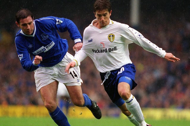 Harry Kewell is pulled back by Everton's David Weir.
