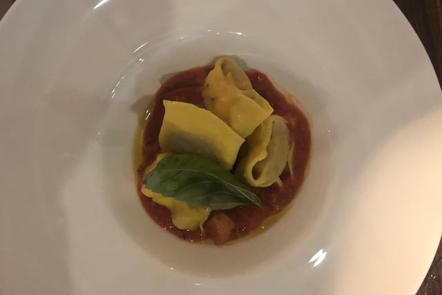 Homemade tortellini stuffed with wild boar, served with a tomato and garlic sauce. SUS-220902-115356001