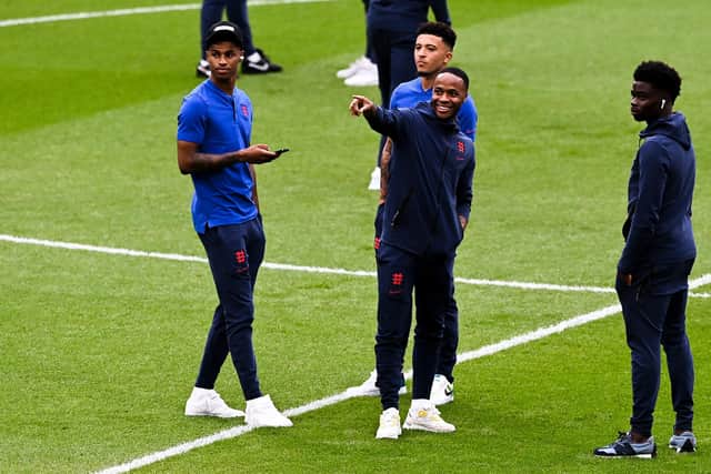 Marcus Rashford, Raheem Sterling, Jadon Sancho and Bukayo Saka of England speak during a pitch inspection prior to the Euro 2020 final (Photo by Facundo Arrizabalaga - Pool/Getty Images)
