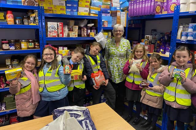 Year two pupils from Hucknall National School with food bank manager Yvonne Campbell