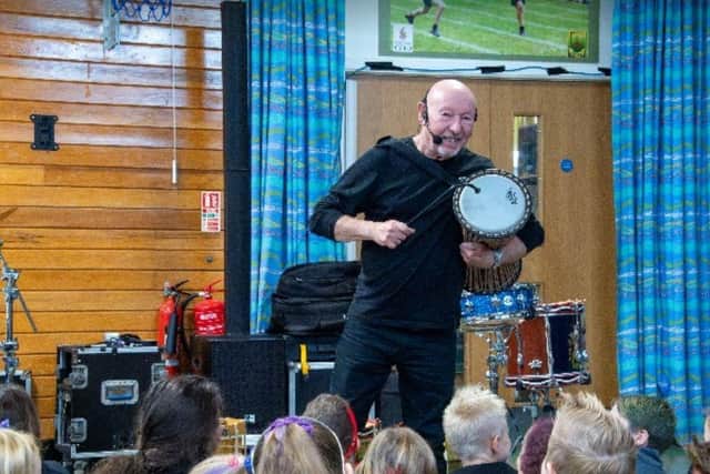 Jeff showed the pupils how to play a number of different drums, including this African one. Photo: Lou Brimble