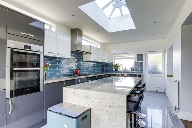 We begin our tour of the house in the stylish breakfast kitchen, which is fitted with a range of modern units. Integrated appliances include a double oven, a gas hob with extractor fan, dishwasher and wine fridge. Eyecatching is its sky lantern roof.