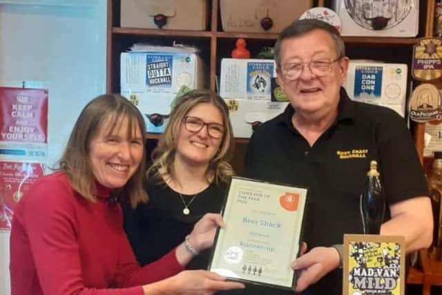 Mark Francis-Parry and his daughter Michelle Humphreys receive their award from Heather Stretton (left) of Nottingham CAMRA