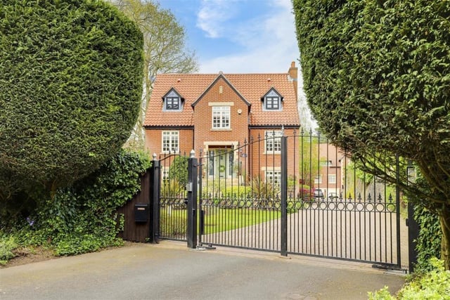 One last lingering look through the gates of the £950,000 Ravenshead house. As well as the driveway, the front comprises a lawned garden, with decorative plants, shrubs and hedged borders, plus outdoor lighting.