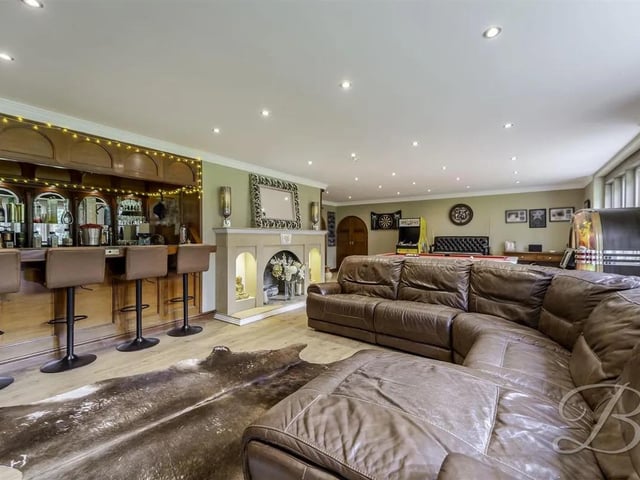 The expansive dining and living room is complete with a built-in bar, perfect for entertaining
