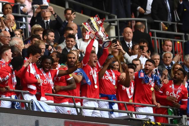 Forest skipper Joe Worrall lifts the trophy following their win over Huddersfield Town in in the EFL Championship play-off final. Photo: Mike Hewitt/Getty Images