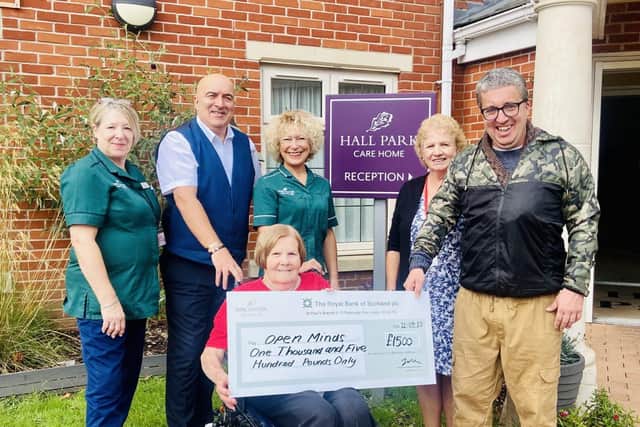Hall Park care home present a cheque to Nottingham charity, Open Minds 