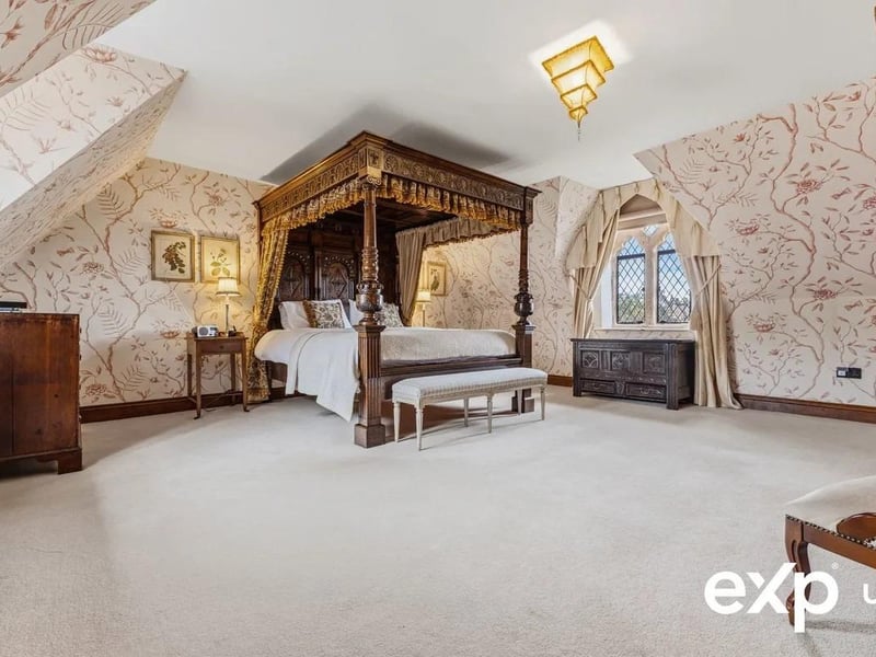 This vast principal bedroom includes fitted wardrobes