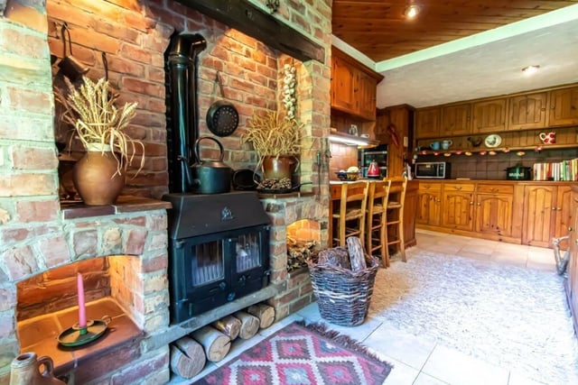 Let's start our tour of Nell Gwynne House in the large L-shaped kitchen, which is full of character. Its main feature is a striking inglenook fireplace and wood-burning stove.
