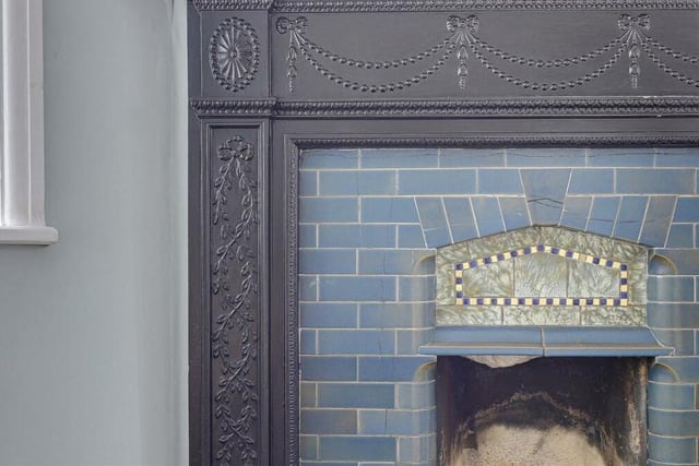 Dotted around the house are features that remind us of its rich history. They include this fireplace with a decorative surround in the dining room.