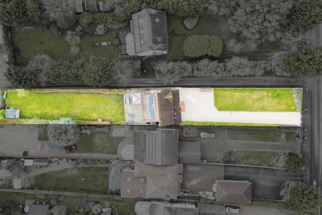 We sign off with this unusual aerial shot, showing how the property fits in to the Papplewick Lane landscape. To the right, the lengthy, gravelled driveway at the front provides off-road parking space for numerous cars. There's also a large lawn and hedged borders.