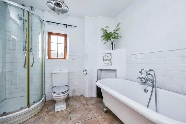 Alongside the two bedrooms on the first floor is this family bathroom. A four-piece suite is fitted with a free-standing bath, a corner shower cubicle, a low-level WC and a wash hand basin. The floor is tiled and there is a chrome, heated towel-rail