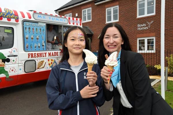 •	Sales consultant Mora Sheard and visitor Viney Wong, 11, enjoy ice creams during the event to high