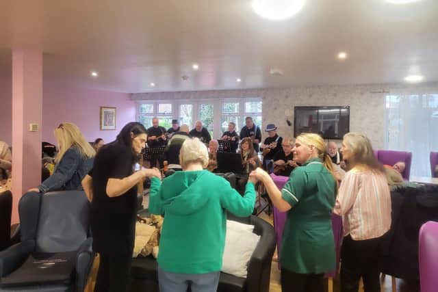 A joyful moment, dancing and swaying to the lively music performance of the Hucknall Ukulele Group
