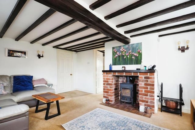 Exposed ceiling beams in the living room remind you of the property's links with Hucknall history.
