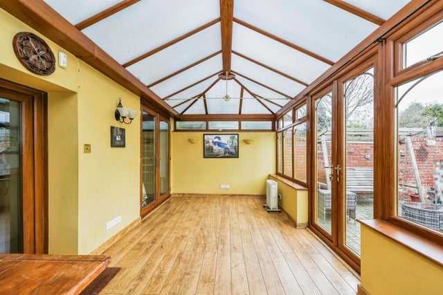 Both the kitchen and the utility room give direct access to this large conservatory at the back of the £325,000-plus property. Built of brick and uPVC, the room boasts wood-effect flooring and French doors leading out to the rear garden.