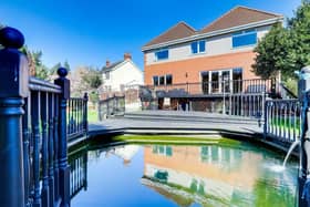 A decked balcony overlooks a garden pond at an impressive five-bedroom, detached house on Sandy Lane in Hucknall, which is on the market for £575,000 with estate agents HoldenCopley.