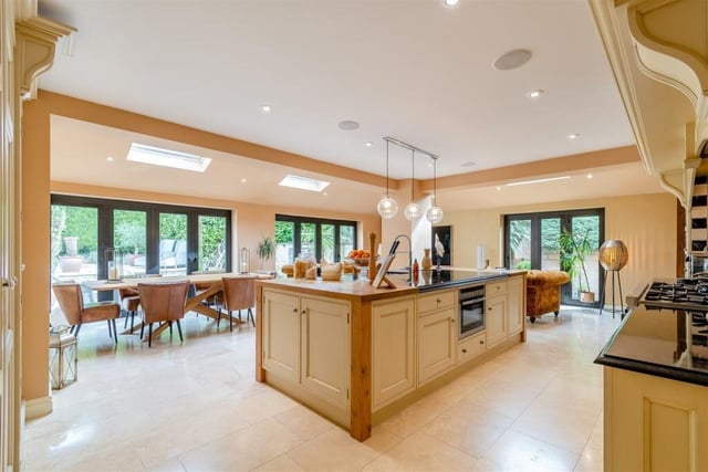 The substantial open-plan kitchen/diner, with living space, can only be described a spectacular. There are three sets of contemporary, aluminium bi-fold doors that lead outside, while the large island in the centre features black granite work surfaces, an inset stainless steel sink and additional butcher's block work surfaces at each end.