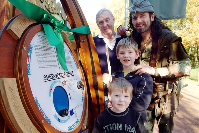Andrew Adams from Ranskill with grandsons Matthew and Joseph Turner, aged eight and five, with Robin Hood, enjoy the Sherwood Forest visitor trail at the Major Oak in Edwinstowe. 2007.