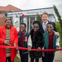 Rubin and Esther Fongue, with triplets Waimi, Mbetmi and Yimi and Paul Walters or Harron Homes cut the ribbon to open the new showhomes. Photo: Submitted
