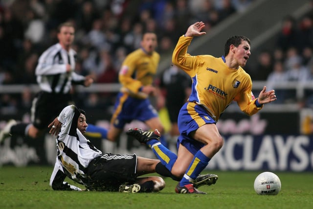 Adam Rundle of Mansfield is fouled by Nolberto Solano.