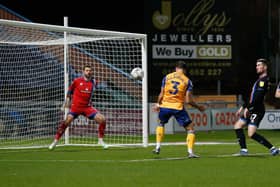 Stephen McLaughlin (left) heads the Stags into the lead against Carlisle. Photo by Chris Holloway/The Bigger Picture.media