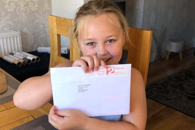 Young Lola Woodfield with her letter from the Queen