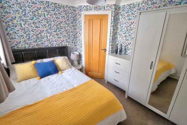 Two of the four bedrooms at the £415,000 property can be found downstairs, including this one, which has a carpeted floor, space for wardrobes and access to an en suite shower room.