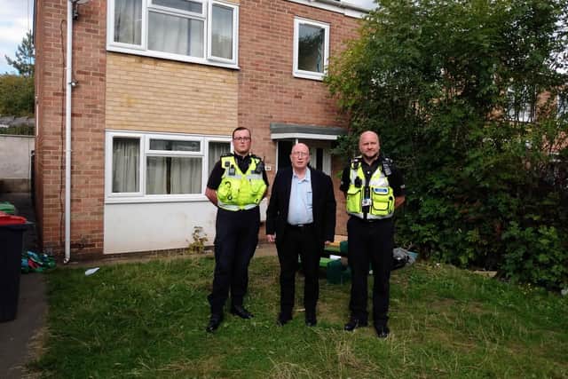 Coun John Wilmott with community protection team officers outside the boarded-up property.