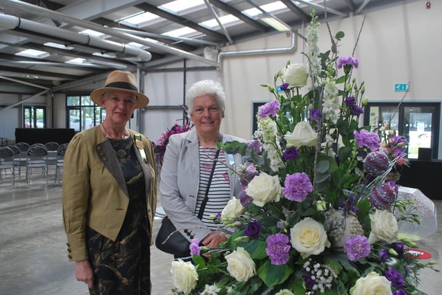 Presidents' Lady Ingrid Barker and Jane Walden, chief steward for floral art, with the best in show, entitled Congratulations, by Cliff Richards.