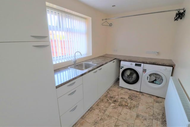 The utility room is large enough for any family. It boasts built-in, modern units, a sink and drainer, plus space and plumbing for a washing machine and tumble dryer. The floor is tiled.