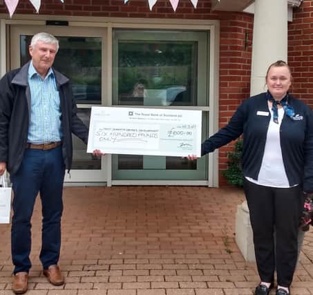 Pictured is Tom Dening from Trent Dementia Services Development and Lisa Moore, deputy home manager at the cheque presentation.