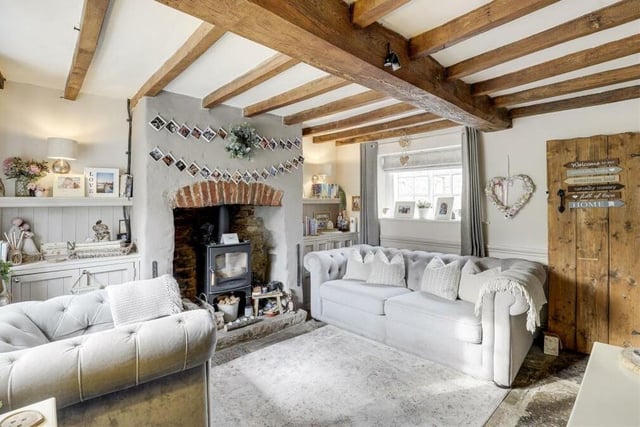We start our tour of the Papplewick cottage in the main reception room, which is this charming living room, complete with exposed beams to the ceiling and flagstone tiled flooring. It is accessed via the characterful, wooden front door of the property.