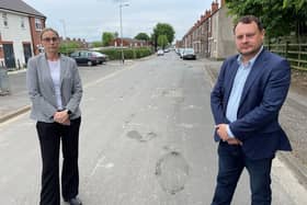 Ashfield District Council leader Jason Zadrozny and councillor Helen-Ann Smith standing on a pothole-ridden road in the district.