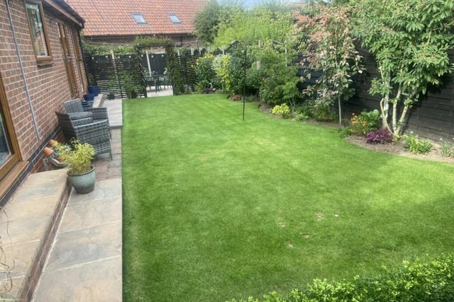 Time to take a brief look outside now, beginning with the private, sunny back garden. It is mainly laid to lawn, with well-stocked tree, shrub and flower borders. Note also the archway at the far end that leads to a patio area.