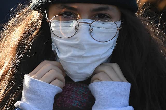 A woman wears a protective face mask in London.  (Photo: Getty).