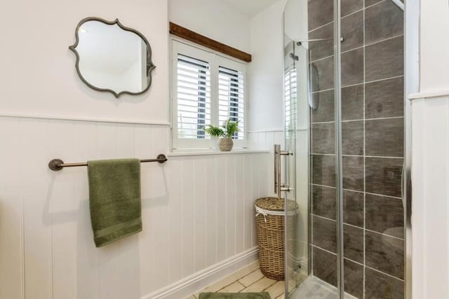 The four-piece family bathroom also features a walk-in shower cubicle.