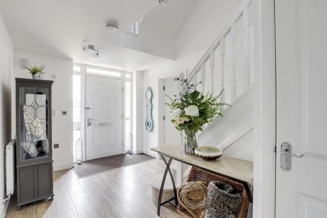 The tone is set for the well-presented £575,000 house by this welcoming entrance hall. It has Amtico wood-effect flooring, a carpeted mat well and built-in storage cupboard.