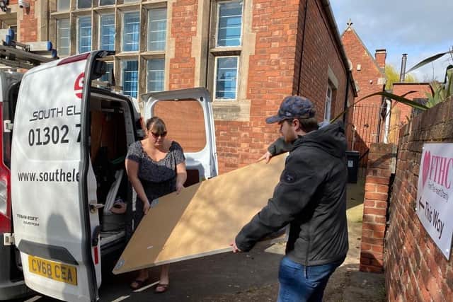 From The Heart Charity charity founder and coordinator Heather McGlone loading furniture into a van with volunteer Greg