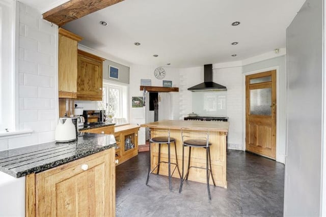 There is space within the kitchen for a Rangemaster cooker, an extractor hood and a fridge freezer. Recessed spotlights and partly tiled walls add to its style.