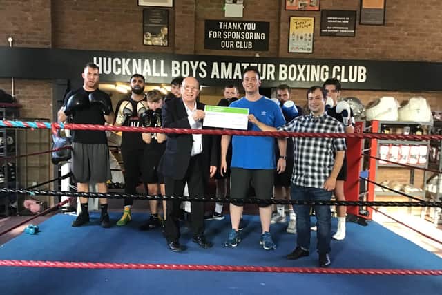 Couns John Wilmott and Lee Water present their cheque to members of Hucknall Boys Boxing Club