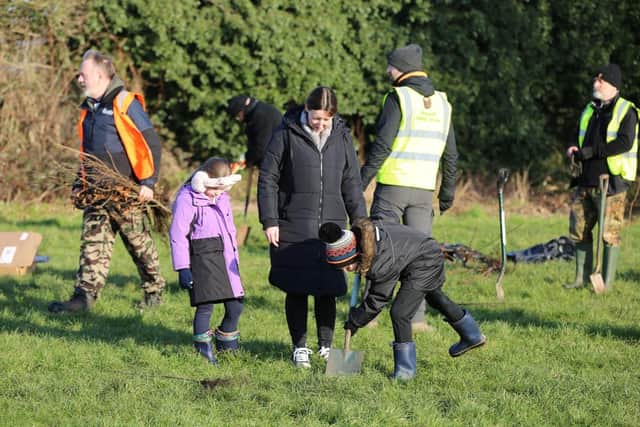 Local youngsters enthusiastically helped with the planting
