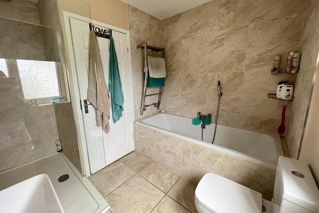 Before we move on to the bedrooms at the bungalow, let's take a peek at the smart family bathroom. A four-piece suite comprises a panelled bath, wash hand basin, WC and large, walk-in 'rainfall' shower.