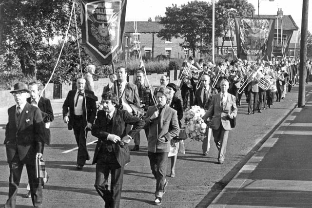 Boldon Colliery miners with their band and banners marching through the village before setting off by bus for the Durham Miners Gala. Remember this from 1980?