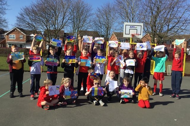 Pupils from Leen Mills School's Leopards class hold up their Letters of Hope