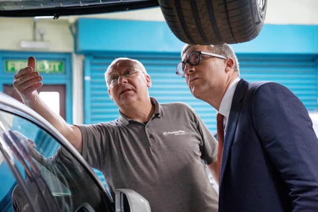 Mechanics instructor, Martyn Steele, shows Lord Timpson his workshop at HMP Stocken.
