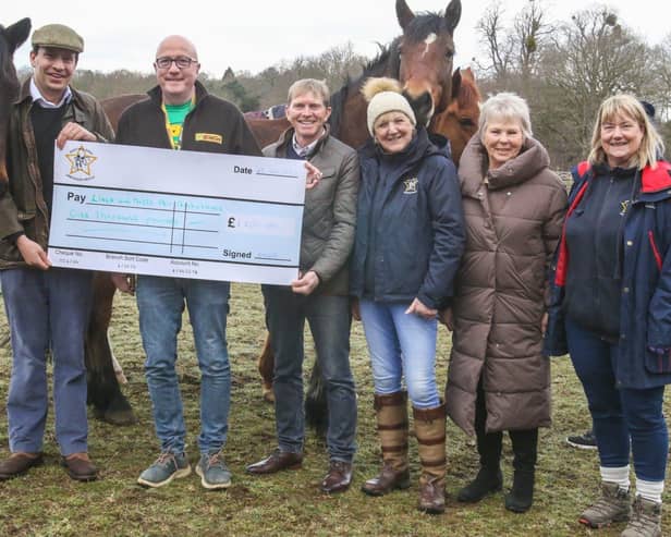 Gregor Pierrepont, of Thoresby Estates, presents a cheque for £1000 from the East Midlands Dressage Group to Andrew Jarvis, from the Lincs & Notts Air Ambulance Service, along with EMDG committee members.