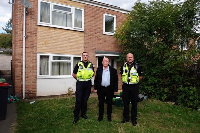 Police and Coun John Wilmott outside the property which will now remain closed for a further six months