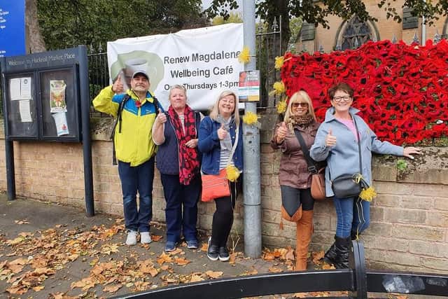Campaigners display yellow ribbons next to the poppies at the church